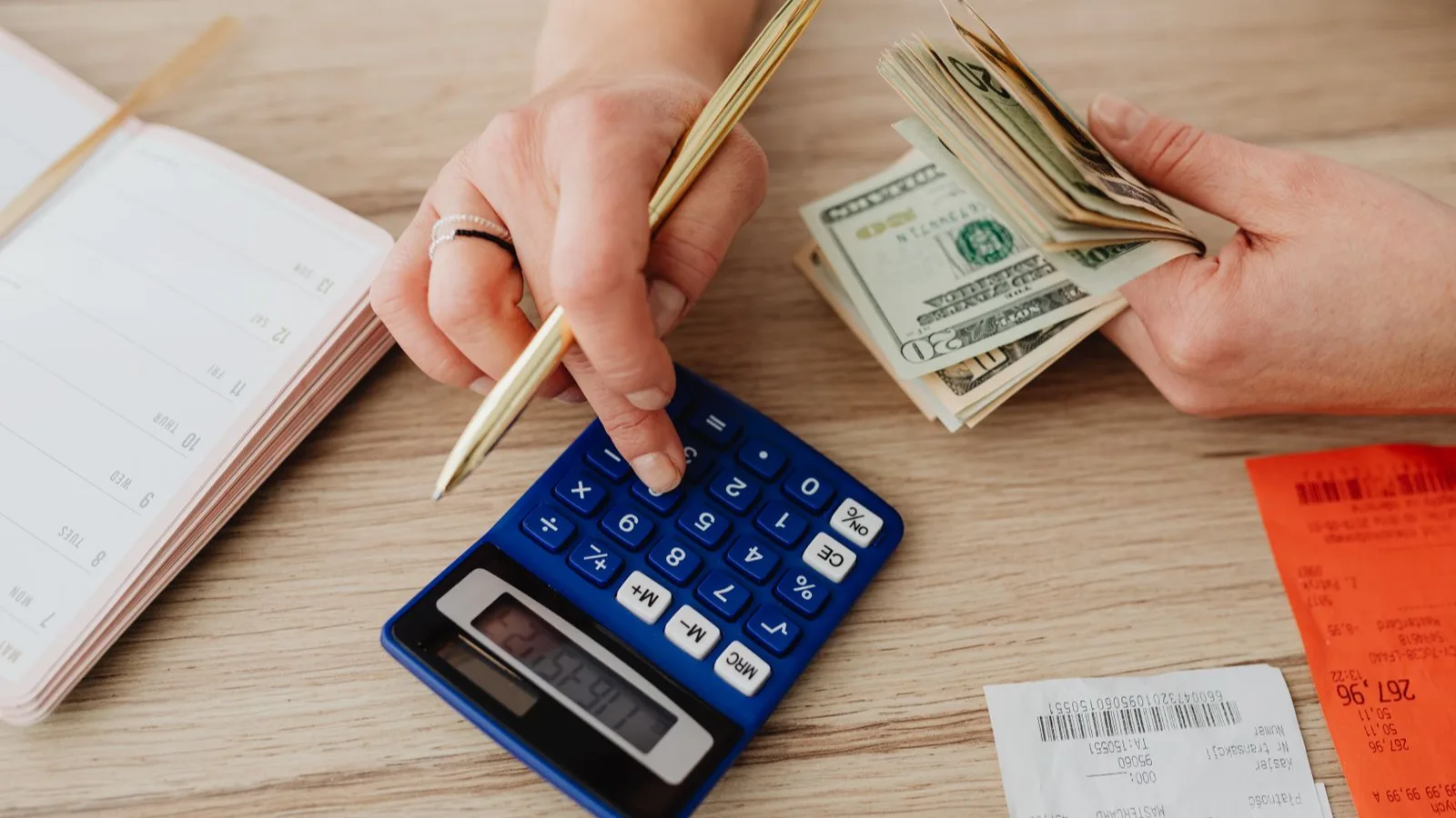 Calculator, cash and notes on a desk