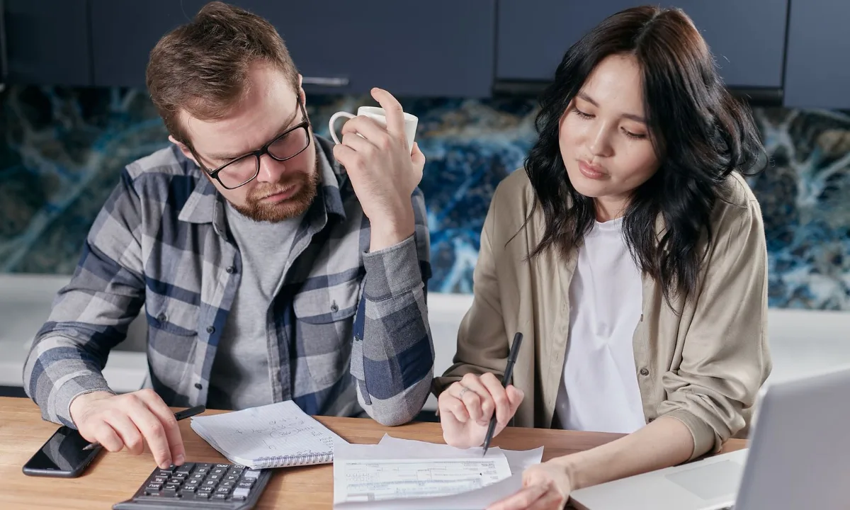 Two people reviewing quotes and documents at a desk