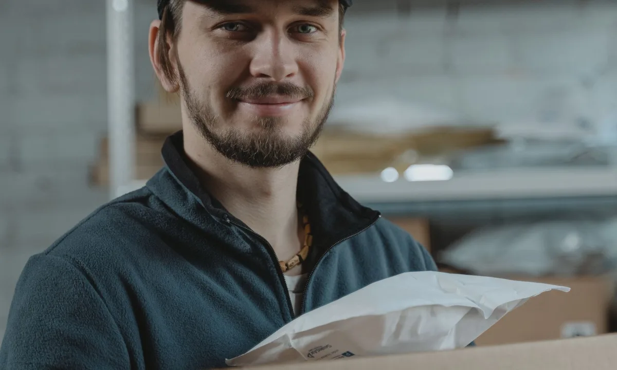 Seller holding a product box