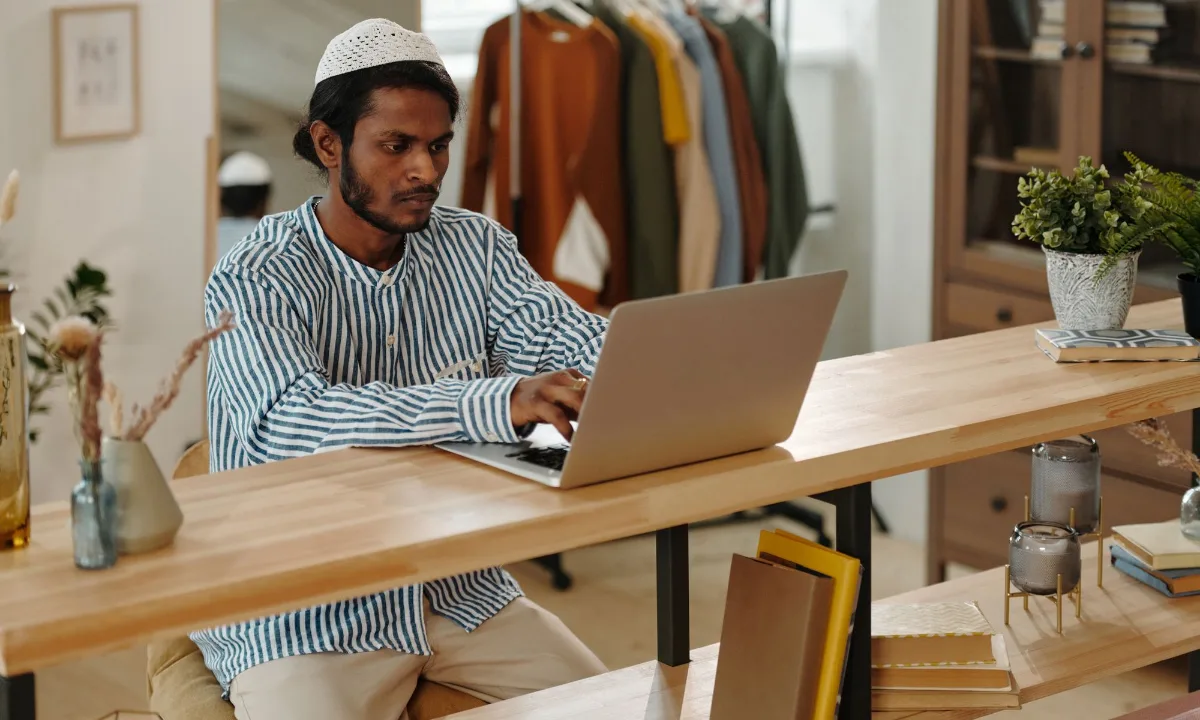 Seller working on listing content at a laptop